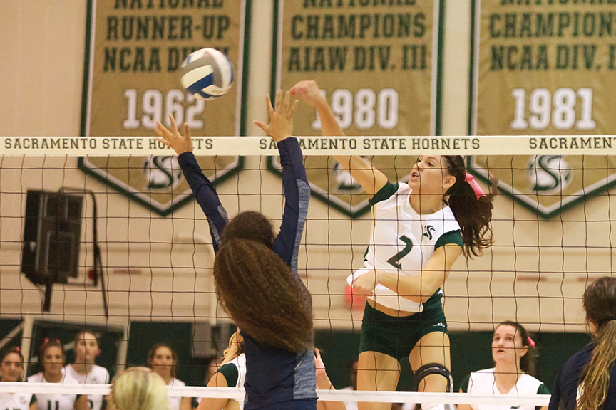 Sacramento State senior midblocker Courtney Dietrich spikes the ball passed Brittni Dorsey of Northern Arizona at the  Nest on Oct. 27, 2016. Dietrich now with the last name Hornsby married former Sac State basketball player Nick Hornsby. 