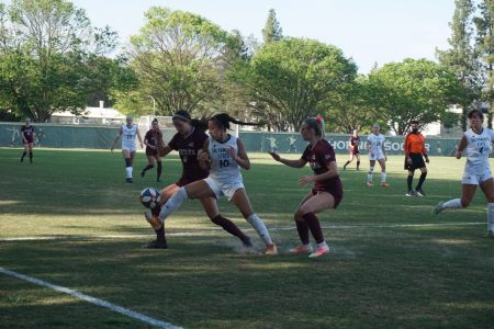  (File photo) Senior forward Tiffany Miras kicks toward the sidelines as two Montana players fight for control of the ball during the game at Sac State on Friday, April 2. The Hornets won their second match of the season Friday 1-0 on a goal by Miras against Portland State. 
