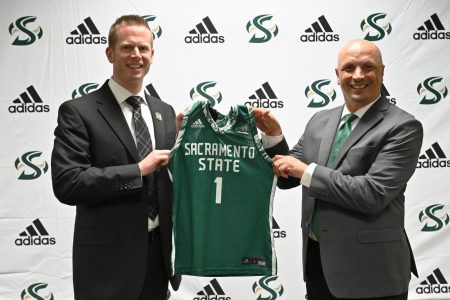 Mark Campbell and athletic director Mark Orr pose on stage Wednesday, April 21, 2021 at Sac State. Campbell was formally introduced as the next head coach for the womens basketball team. Credit: Hornet Athletics