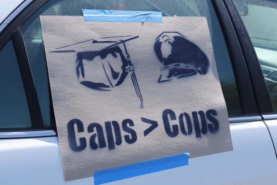 A “Caps > Cops” sign was taped to a protester’s car at a caravan in support of defunding university police in front of Sacramento State’s police department on Saturday May 1, 2021. “Caps” is in reference to an acronym of “Counseling And Psychology Services.”