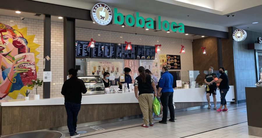 Customers order from Boba Loca inside the Arden Fair mall May 5, 2021. Workers, including assistant manager Lillian Phan, on the left behind the counter, push tea out to waiting customers.