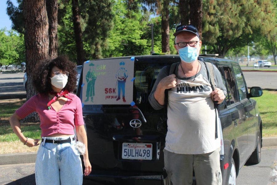 Sociology student at Chico State Melys Bonifacio-Jerez, left, stands next to protester Guillermo Marsh at the May Day Car Caravan in support of defunding university police at Sacramento State’s Police Department on Saturday, May 1, 2021. CSU Students For Quality Education demanded removal of university police on the 23 CSU campuses during the Caravan.