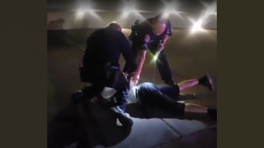 Sergeant Vincent Burton (left) of Sacramento State’s Police Department kneels on the neck of a cyclist for approximately 23 seconds while handcuffing him after Corporal Doug Nguyen (right) deployed his stun gun twice into the suspect on June 4, according to anonymous sources. Photo courtesy of Francisco Munoz.