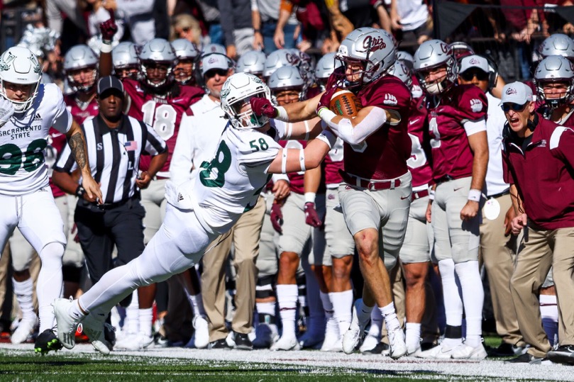 Sac State freshman linebacker Mitchell Wolfe (58) gets stiff-armed as he attempts to tackle Montana sophomore safety Garrett Graves (5) on Oct. 16, 2021, at Washington-Grizzly Stadium. The Hornets pulled off the upset and beat the #5 ranked Grizzlies for the first time in Missoula by a score of 28-21. 