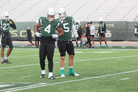 Senior linebacker Taylor Powell (4) and senior linebacker Marcus Hawkins (5) communicate in between plays on Oct. 19, 2021, at Hornet Stadium. Hawkins and Powell have combined for 82 total tackles on the season.
