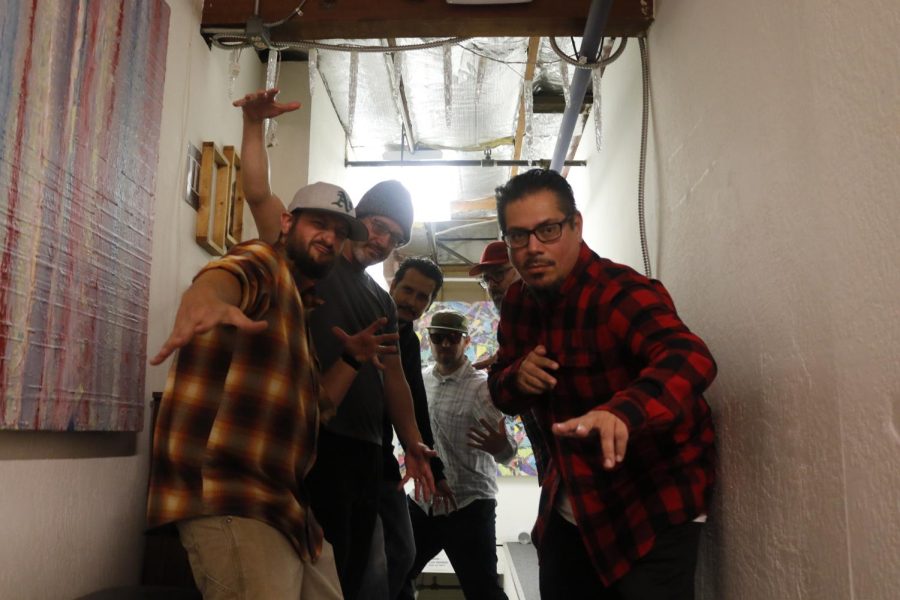 Peligro Brass members (left to right) Jared Collins, Michael Lapilusa, Ron Ochoa, Rob Keedy, Marco Guerrero and Sam Miranda pose at the staircase leading to their practice studio on Oct. 26, 2021. The band practices at Cider Sessions near the Two River Cider Company. (Note: Member Chris Tadina not present at band rehearsal).