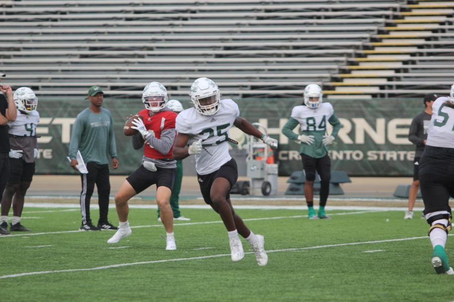 Junior quarterback Asher O’Hara  looks to throw the ball to freshman running back Elijah Tau-Tolliiver at practice on Oct. 19, 2021, at Hornet Stadium. O’Hara leads the team in Rushing yards and touchdowns this season. 
