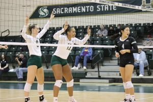  Sac State volleyball sophomores, outside hitter Bridgette Smith (8) and middle blocker Kalani Hayes (12), face off against Portland State’s senior setter Ally Wada (4) at the net on Oct. 19, 2021. The Hornets won in three sets and broke Portland State’s seven-game win streak.
