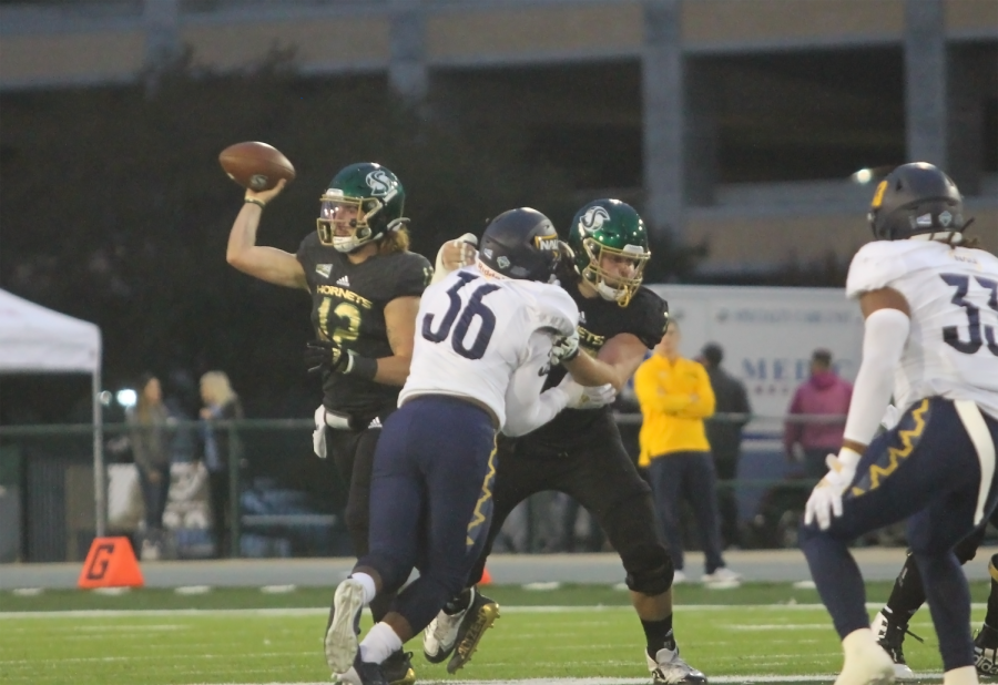 Junior quarterback Jake Dunniway (12) throws a screen to his right on Oct. 23, 2021, at Hornet Stadium. Dunniway was 21-35 for 328 yards and two touchdowns in the Hornets’ blowout of the Northern Arizona Lumberjacks 44-0.