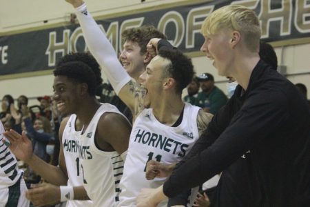 Sac State’s bench celebrates after a lob dunk by sophomore combo forward Cameron Wilbon on Thursday, Nov. 4, 2021, at the Hornets Nest. The Hornets defeated the Red Hawks after a second half surge.
