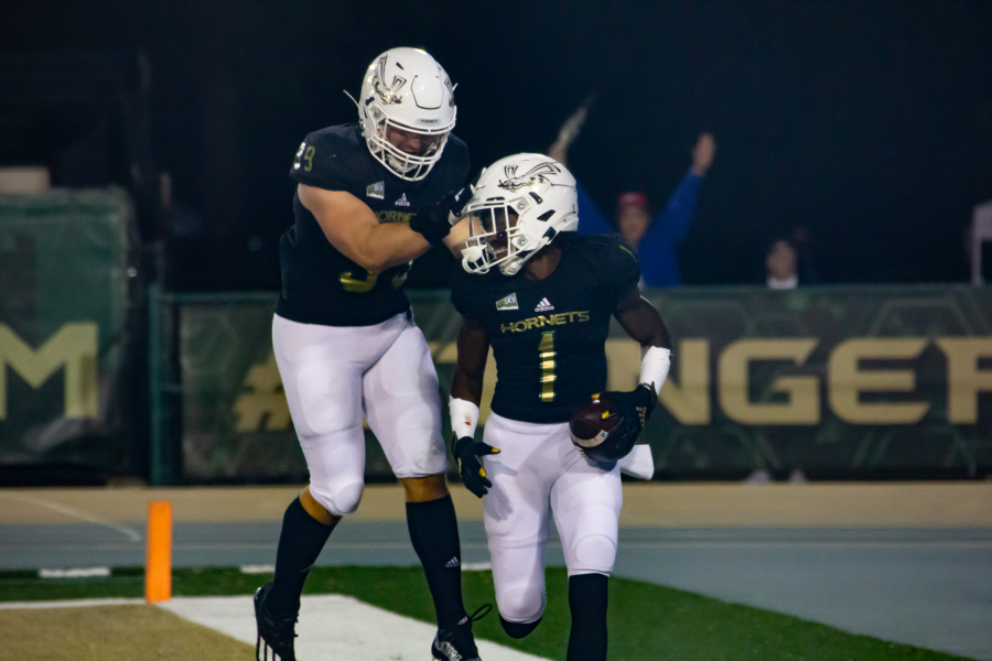 Senior cornerback Munchie Filer III (1) celebrates with freshman defensive lineman Leke Fashola (99) after intercepting a pass for a touchdown at Hornet Stadium on Nov. 6, 2021. The Hornets also had a sack and a fumble recovery.