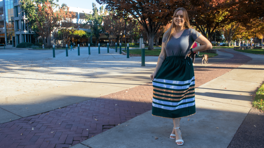 Amanda+Croteau+stands+on+Sacramento+State%E2%80%99s+campus+wearing+an+emerald+green+ribbon+skirt.+As+a+citizen+of+Cherokee+Nation+and+president+of+Sac+State%E2%80%99s+Ensuring+Native+Indian+Traditions+club%2C+she+says+she+hopes+to+help+other+Native+students+feel+like+they+belong.+