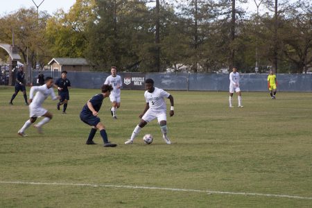 Freshman forward Jhared Willcot attempts to fake out a UC Davis defender on Saturday, Oct. 30, 2021. Willcot finishes the year with a goal and two assists.
