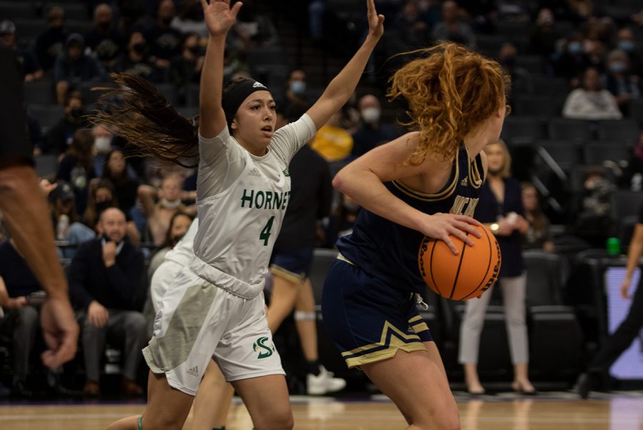 Senior guard Summer Menke drives to the basket against UC Davis  freshman Sydney Burns. Sacramento State women’s basketball played the worst game of its season so far in a 75-46 loss to UC Davis on Nov. 23, 2021, at the Golden 1 Center.