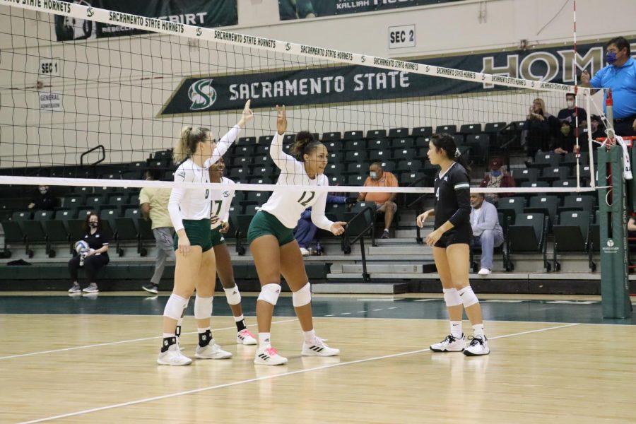 Sacramento State volleyball’s sophomore middle blocker Kalani Hayes (12) and sophomore outside hitter Bridgette Smith (8) face off with Portland State senior setter Ally Wada (4) at the Hornets Nest on Tuesday, Oct. 12, 2021. The Hornets were eliminated from the Big Sky tournament in a 3-2 loss against Portland State in the Big Sky conference tournament hosted in Utah on Thursday. 