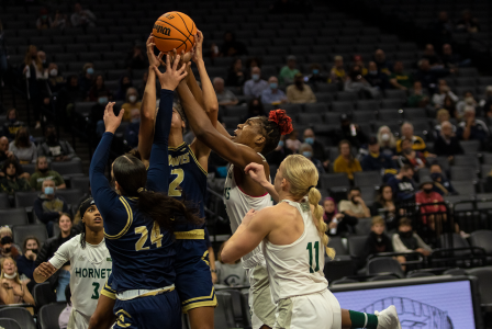 Sophomore center Isnelle Natabou gets swarmed by defenders while grabbing a rebound during both Sacramento State’s and UC Davis’ women’s teams’ first ever Causeway Classic at the Golden 1 Center on Nov. 23, 2021. Sac State womens basketball loss to UC Davis 75-46.
