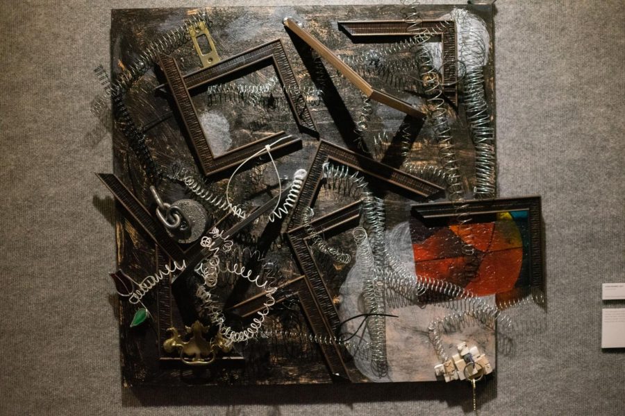 Laura Hansen’s “Constrained,” featured in the “META:morphosis” exhibition on Nov. 23, 2021, is a mixed-media assemblage which features broken frames, chains and metal coils. The exhibition ran in the University Union Gallery from Nov. 22 through Dec. 2.