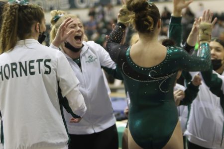 The Hornets celebrating after a dismount during the vault event against Air Force Saturday, Feb. 5, 2022. The Hornets defeated the Falcons 194.225 to 194.000 in the team’s first match in the Nest in over two years.