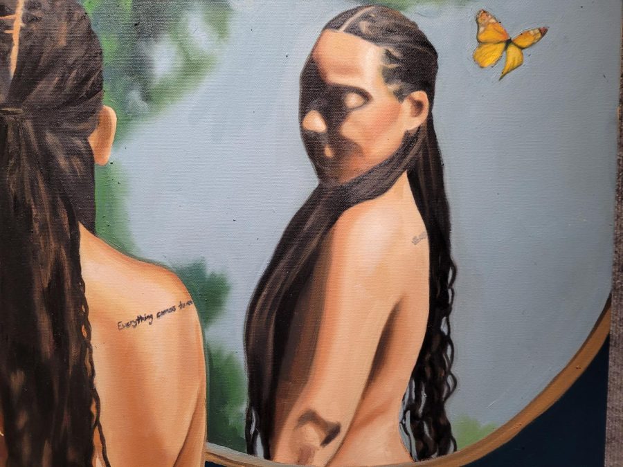 A detailed look at Aliyah Sidqe’s oil painting “Assessing the Damages, hung in the Union Gallery at Sac State on Feb. 1. Sidqe said that the tattoo partially shown in the self-portrait reads “Everything Comes to An End.” 