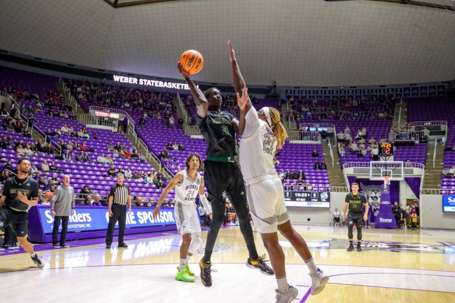 Junior center Jonathan Komagum attempts a hook shot in the low-post against Weber State Thursday, Feb.18, 2022, at Dee Events Center. Komagum finished with five rebounds and one steal as the Hornets suffered their sixth straight defeat with a 65-50 loss against the Wildcats.
