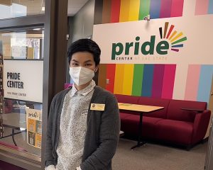 Tranh Pham, the Pride Center coordinator poses in front of the Pride Center entrance on Feb 25. “When students come in here, it is a delight and privilege to be trusted to share that journey,” Pham said. Photo by: Hannah Asuncion

