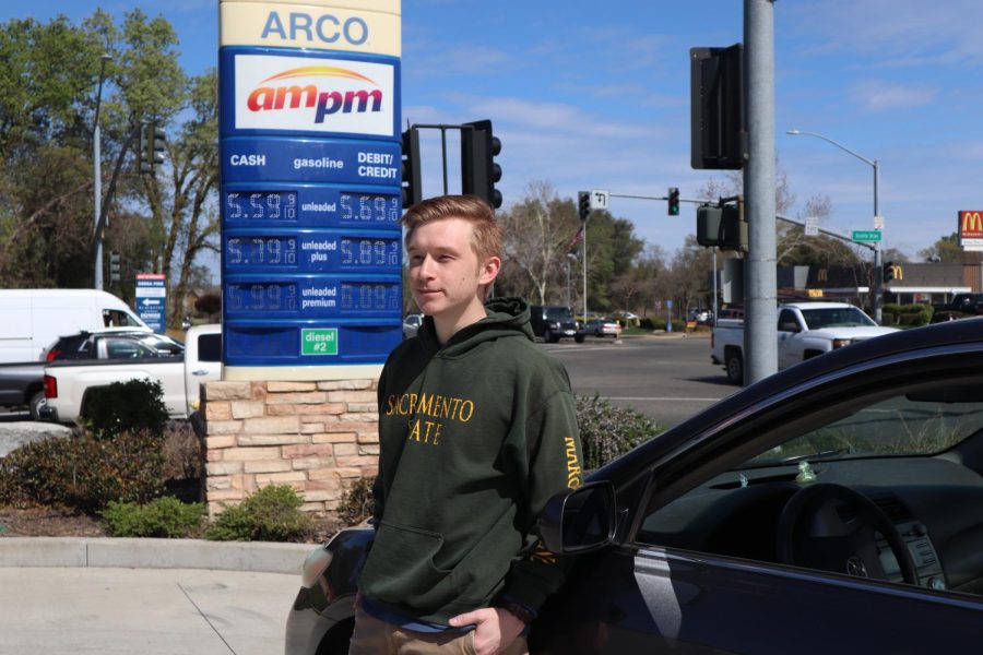 Fourth year economics major Daniel Kuffel stands in front of an Arco gas station on Thursday, March 17, 2022. He is one of many commuter students at Sacramento State University and says that the increase in gas prices within the state is a pain. 