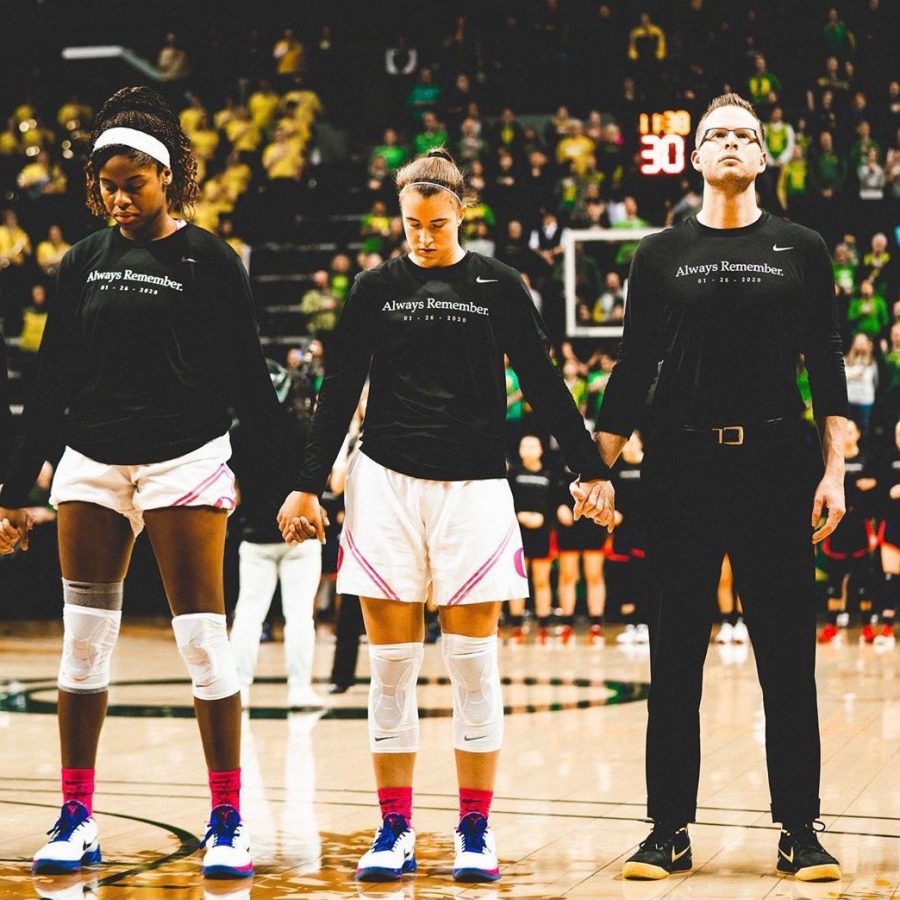 Ruthy Hebard(left), Sabrina Ionescu(middle) and Mark Campbell(right) join hands as they take time to remember Kobe Bryant after his death. Campbell would help coach that team to a 31-2 record.