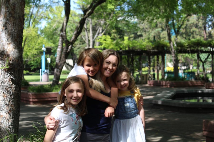 (L-R) Charlotte, Elliotte, Ashley, and Juliette Frost pose together in the quad near the library on March 31, 2022. Frost said she hopes her graduation will also be a celebration for her daughters and not just for herself. 
