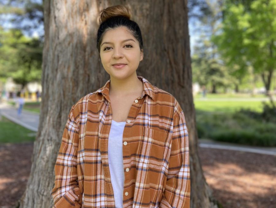 Mujeres Ayudando La Raza co-coordinator and third-year anthropology major Lexi Bravo poses in front of a tree outside of the Sac State Library on Thursday, April 7, 2022. Bravo said MAR helps Latinx students become more involved in their community. (Photo by Alexis Perales)