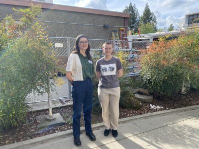 Elizabeth Ballard-Branco (left) and Sage Stanley (right) stand in the middle of the breezeway at Kadema Hall on Tuesday, March 15, 2022. The renovation has made ceramic making and printmaking more difficult and prevented some students from completing their artworks.