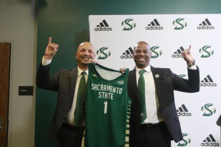 [L-R] Sac State athletic director Mark Orr and newly hired Sac State men’s basketball coach David Patrick pose with a jersey during a press conference Tuesday April 12, 2022 at the Sac State Welcome Center. Patrick is set to lead the Hornet program after most recently serving as an assistant with the Oklahoma Sooners last season.
