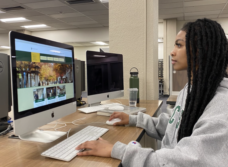 Jasmine Joseph sits inside the University Library on Tuesday, April 12, 2022.  Joseph is one of many students who have struggled to find online options for next semester as Sac State hopes to bring more students back on campus. 