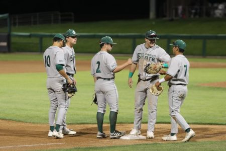 Sophomore infielder Gunner Gouldsmith (middle) and senior infielder Steven Moretto(second from right) greet senior Keith Torres(far right) with fist bumps as he takes the field at Klein Family Field against University of the Pacific on Tuesday, April 19, 2022 in Stockton, California.,Everybody contributed and did their part to get the win tonight, said Torres, who finished the game 4-4.
