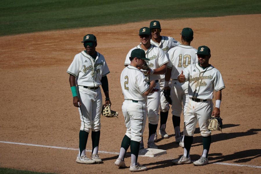 Hornet fielders get set to take the field as senior shortstop Keith Torres gives a thumbs up to the dugout Friday April 15, 2022 at John Smith Field. Sacramento State sits in third place in the WAC conference at 9-9.
