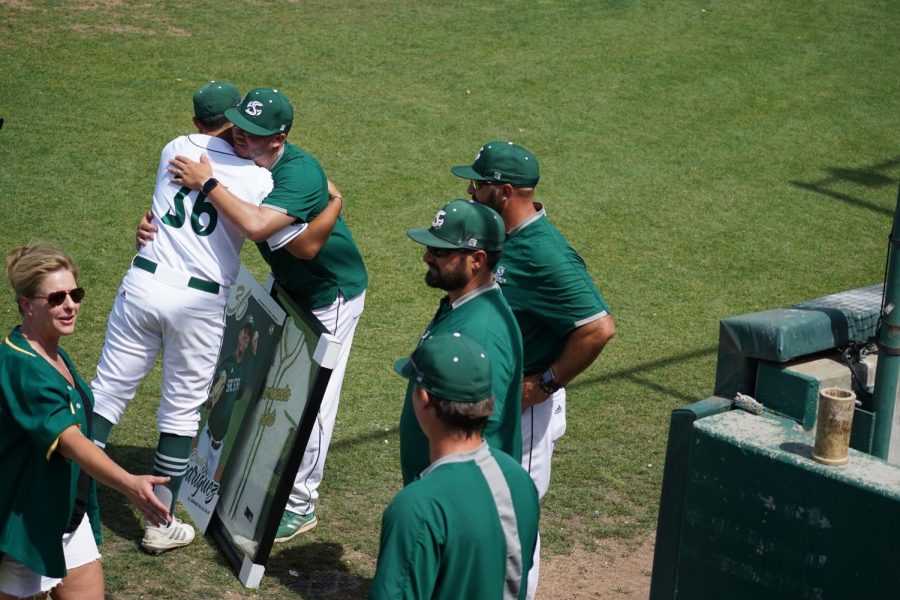 Senior Dylan McPhillips and team manager Reggie Christansen embrace on the field for  senior day at John Smith Field on Sunday, May 15, 2022. McPhillips has thrown out 27 baserunners in his Sac State career.
