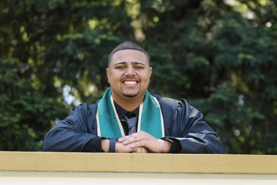 Jordan Parker smiles from ear to ear in his graduation garb on Sunday, April 17, 2022 at Sacramento State. Parker’s grin has lifted the spirits of The State Hornet for the past three years as we determined our role during the pandemic, according to several of its staff and editors.
