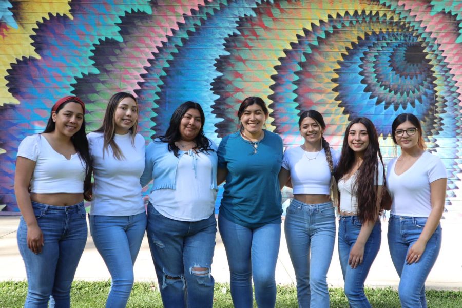 Mujeres Ayudando la Raza board members (L-R) Breana Fabian, Conny Morales, Karina Balthazar, Kim Salgado, Noelia Barron, Maria Amador and Lexi Bravo pose in front of the mural on the Studio Theatre on Tuesday, May 3, 2022. MAR won ‘Best Club’ in the 2022 Best of Sac State poll. (Photo by Alexis Perales)
