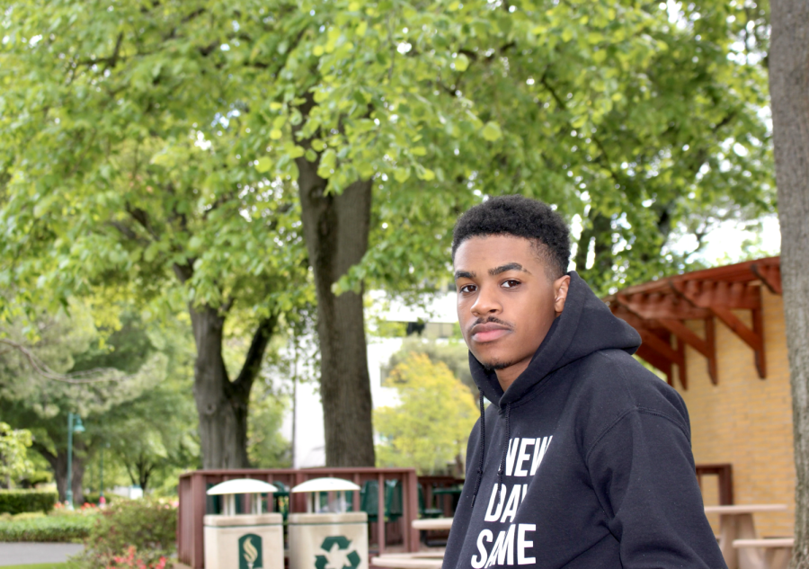 Fourth year economics major Malachi Powell sits at a table outside of Lassen Hall and Java City Roundhouse on Friday, April 22, 2022. Powell said he has an unsure but positive outlook towards what his future career path may be after earning his undergraduate degree. 
