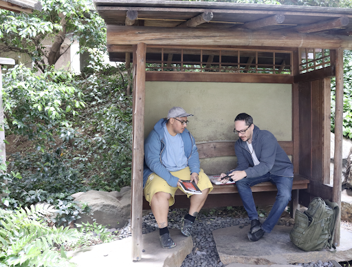 (L-R) Genesis Torres and Jack Gephart discuss philosophical ideas at the Sokiku Nakatani Tea Garden below the Sac State library. “This [tea garden] is a space I use to regroup my thoughts or take a moment from the chaos going on above,” Gephart said. 
