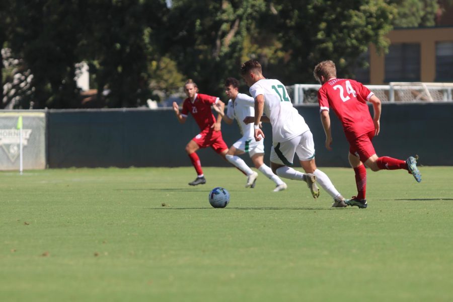  [FILE]: Sac State junior forward Michael Gonzalez dribbles the ball through the Loyola Marymount University defense on Sept. 8 in a 2-1 win for the Hornets. Gonzalez is tied for second on the team with two goals scored this season.