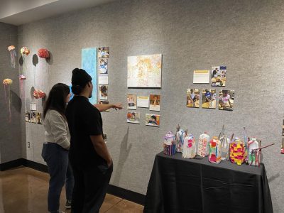 Fourth-year students Andrew Diaz and Veronika Akopyan admire the behind-the-scenes photos in the exhibit on Sept. 19, 2022. The artwork was made by kids as young as six months.

