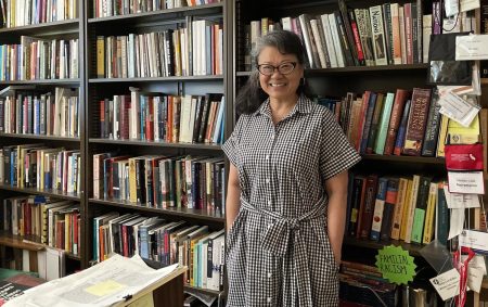 Dr. Hellen Lee stands by her many educational books on Tuesday Sept. 27, 2022. “I was really concerned if I could actually do the work. But I talked to my dean and my associate dean, and after some conversations, it looked like it was possible for me to do it, Lee said. 