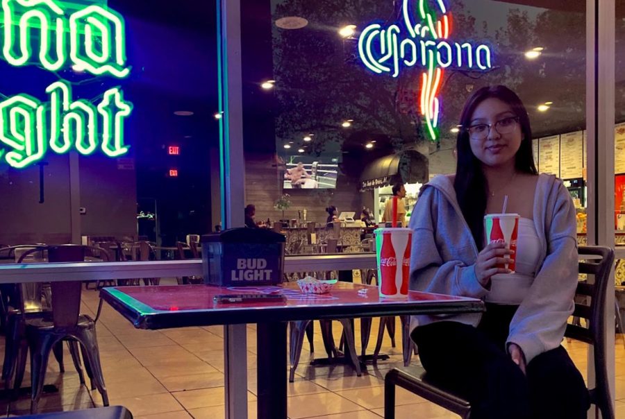 Stephanie Cornejo, a third-year communications major at Sac State sits outside of El Favorito Taqueria on Oct. 3, 2022. Cornejo says she enjoys sitting in the patio area while sipping on an an agua fresca. 