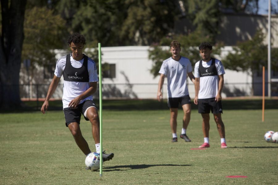 Freshman defender Lucas Gimenez (left, with ball), junior midfielder Zack Mason (center) and senior midfielder Erik Lopez (right) practice on Sept. 29, 2022, at the Hornet Practice Field. The team won their first Big West Conference game on Wednesday, Sept. 28, 2022 1-0 against CSU Bakersfield