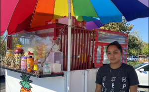 Sacramento street vendor Silvia Perez poses in front of the fruit cart she helps run on Tuesday Oct. 4, 2022. Perez said she thinks street vendors now feel more protected with the passing of Senate Bill 972.