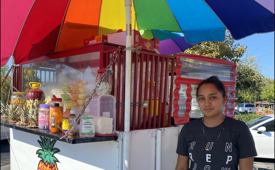 Sacramento+street+vendor+Silvia+Perez+poses+in+front+of+the+fruit+cart+she+helps+run+on+Tuesday+Oct.+4%2C+2022.+Perez+said+she+thinks+street+vendors+now+feel+more+protected+with+the+passing+of+Senate+Bill+972.