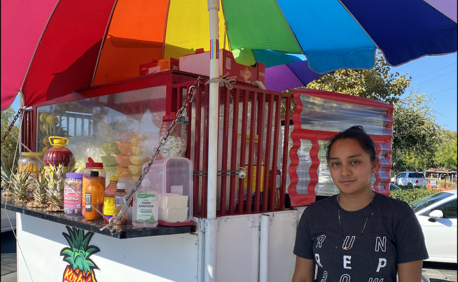 Sacramento street vendor Silvia Perez poses in front of the fruit cart she helps run on Tuesday Oct. 4, 2022. Perez said she thinks street vendors now feel more protected with the passing of Senate Bill 972.