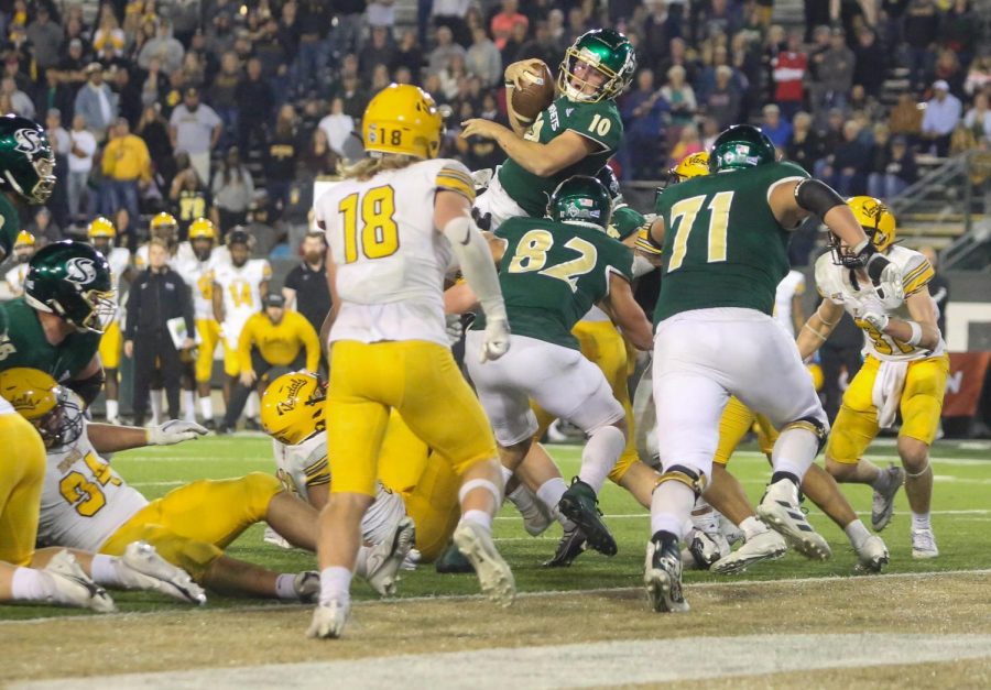 Senior Sac State quarterback Asher O’Hara twisting mid-air into the endzone to score the Hornets game-winning touchdown over Idaho Saturday, Oct. 29, 2022 at Hornet Stadium. Sacramento State held off an upset-hungry Vandals team Saturday with a 31-28 victory.
