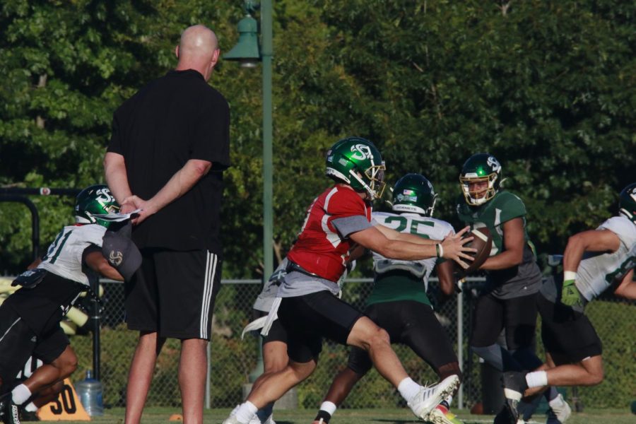 Assistant head coach and offensive line coach Kris Richardson watches as senior quarterback Asher O’Hara receives the snap at practice on Tuesday, Sept. 27, 2022. Sac State has never started 5-0, a feat they wish to conquer this Saturday at home against Northern Colorado.
