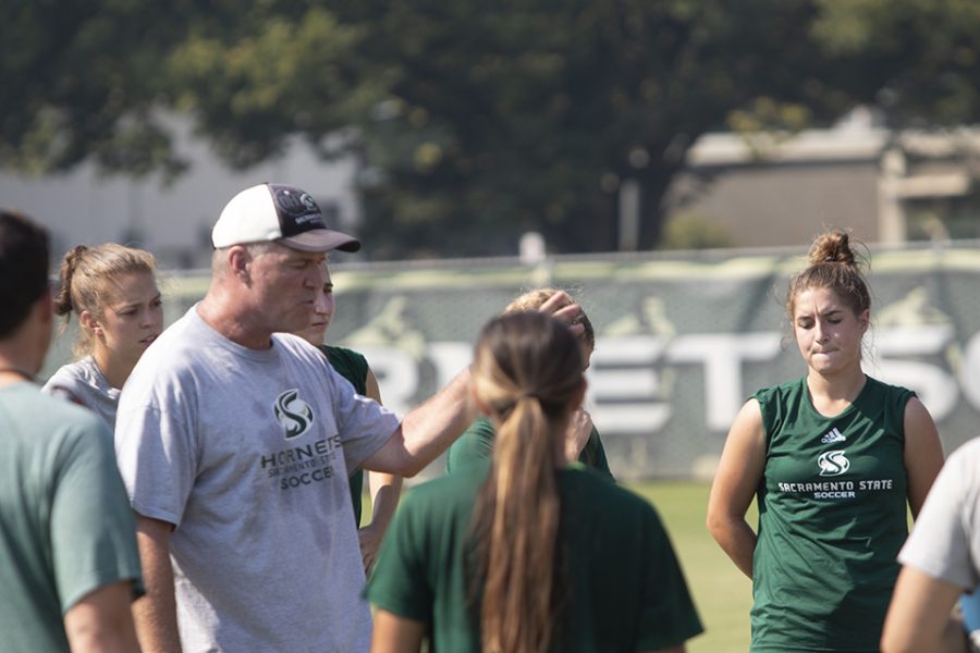 Head coach Randy Dedini speaks to his team in a huddle during practice on Friday, Sept. 25, 2021, at Hornet Soccer Field. The Hornets are set to open up Big Sky play in a road matchup against Weber State on Wednesday.